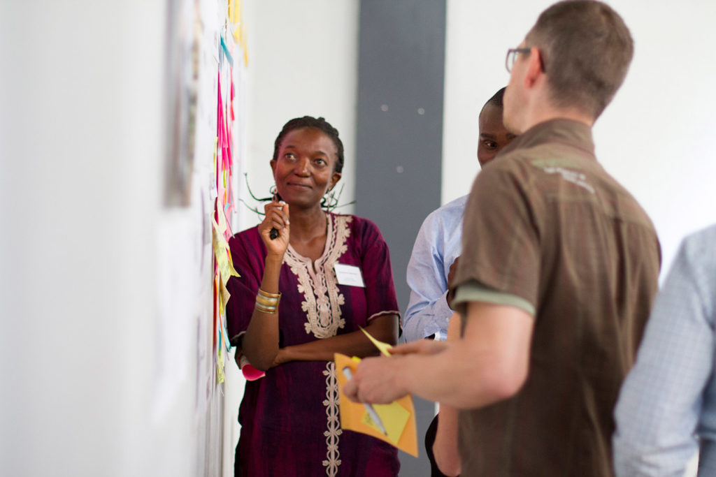 black woman and white man looking at the whiteboard