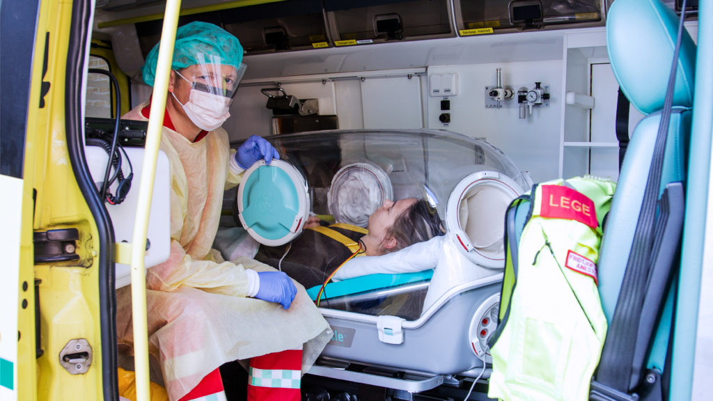 health care worker inside the ambulance with a patient in the epishuttle